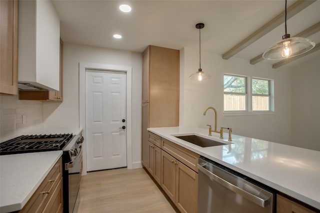 5507 Gloucester Ln, Austin, TX 78723 - kitchen with appliances with stainless steel finishes, recessed lighting, light countertops, light wood-style floors, and decorative light fixtures