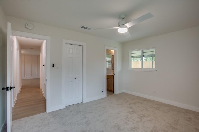 5507 Gloucester Ln, Austin, TX 78723 - unfurnished bedroom with light colored carpet, a closet, a ceiling fan, and ensuite bath