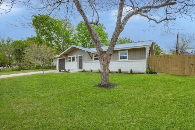 5507 Gloucester Ln, Austin, TX 78723 - view of front of house with board and batten siding, brick siding, concrete driveway, and an attached garage