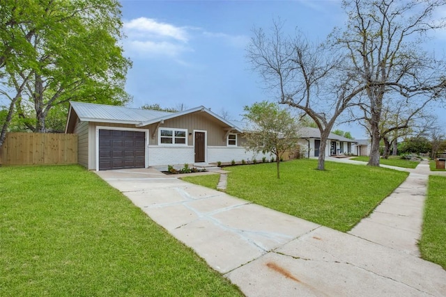 5507 Gloucester Ln, Austin, TX 78723 - mid-century home featuring a garage, driveway, brick siding, and a metal roof