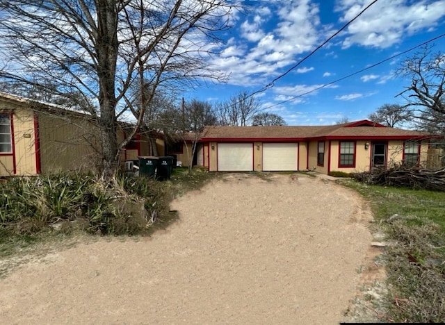 10208 Thomaswood Ln, Austin, TX 78736 - ranch-style house with dirt driveway and an attached garage