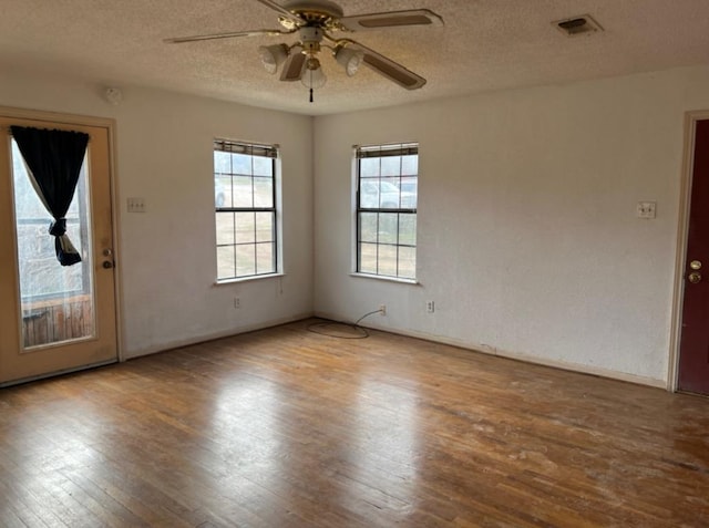 10208 Thomaswood Ln, Austin, TX 78736 - spare room with wood finished floors, ceiling fan, a textured ceiling, and baseboards