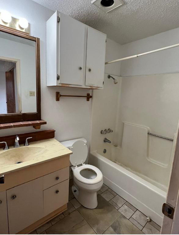 10208 Thomaswood Ln, Austin, TX 78736 - full bath with a textured ceiling, vanity, bathing tub / shower combination, toilet, and tile patterned floors
