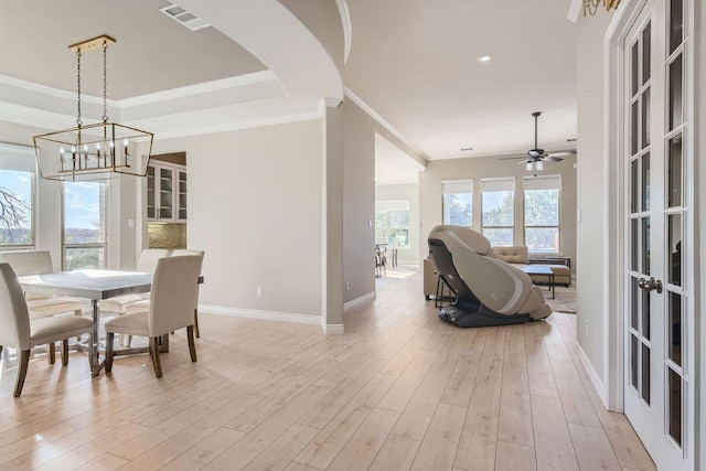 21808 Esmeralda Dr, Spicewood, TX 78669 - dining room with a chandelier, ornamental molding, baseboards, light wood-style flooring, and ceiling fan