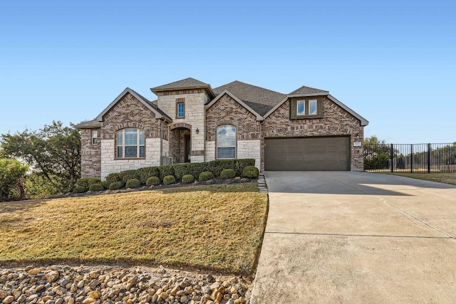 21808 Esmeralda Dr, Spicewood, TX 78669 - french provincial home with stone siding, driveway, a garage, and roof with shingles