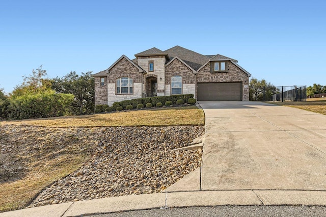 21808 Esmeralda Dr, Spicewood, TX 78669 - french country style house with stone siding and concrete driveway