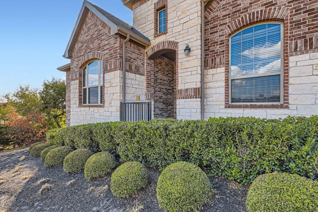 21808 Esmeralda Dr, Spicewood, TX 78669 - view of exterior entry featuring stone siding and brick siding