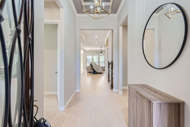 21808 Esmeralda Dr, Spicewood, TX 78669 - foyer with crown molding, a chandelier, light wood finished floors, baseboards, and ceiling fan