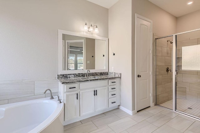 21808 Esmeralda Dr, Spicewood, TX 78669 - full bathroom with vanity, a stall shower, a garden tub, and tile patterned floors