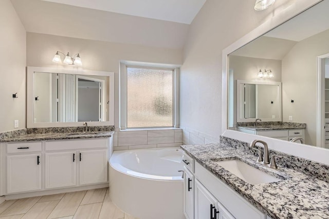 21808 Esmeralda Dr, Spicewood, TX 78669 - bathroom with two vanities and a garden tub