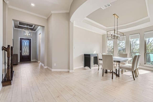 21808 Esmeralda Dr, Spicewood, TX 78669 - dining area featuring a chandelier, baseboards, crown molding, light wood finished floors, and arched walkways