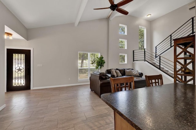3055 Lakeview Dr, Canyon Lake, TX 78133 - entrance foyer with ceiling fan, beamed ceiling, baseboards, stairway, and high vaulted ceiling