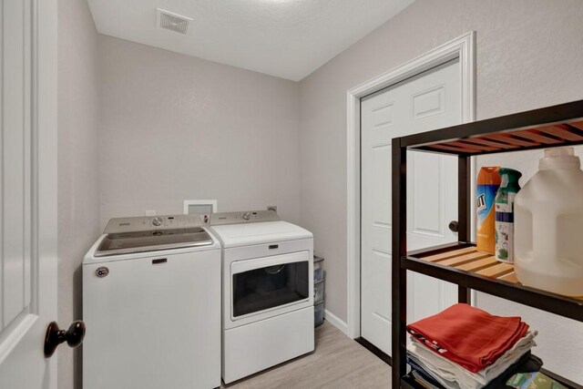 3055 Lakeview Dr, Canyon Lake, TX 78133 - laundry room featuring independent washer and dryer and light wood-style floors