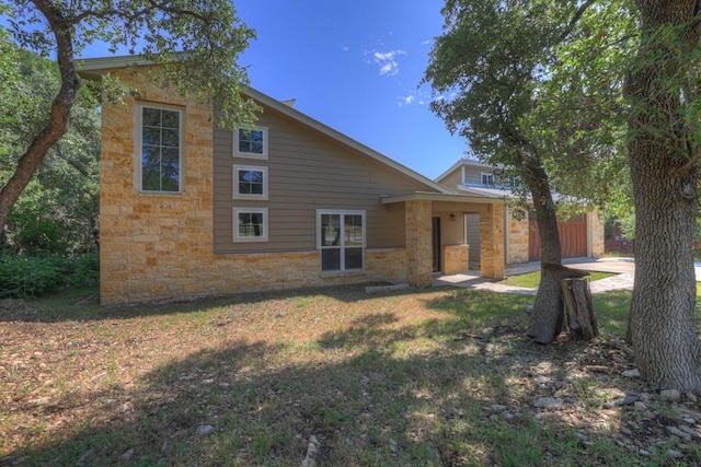 3055 Lakeview Dr, Canyon Lake, TX 78133 - back of property featuring stone siding and a yard