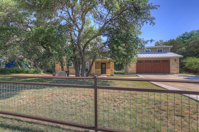 3055 Lakeview Dr, Canyon Lake, TX 78133 - view of front of house with an attached garage, driveway, metal roof, and a standing seam roof