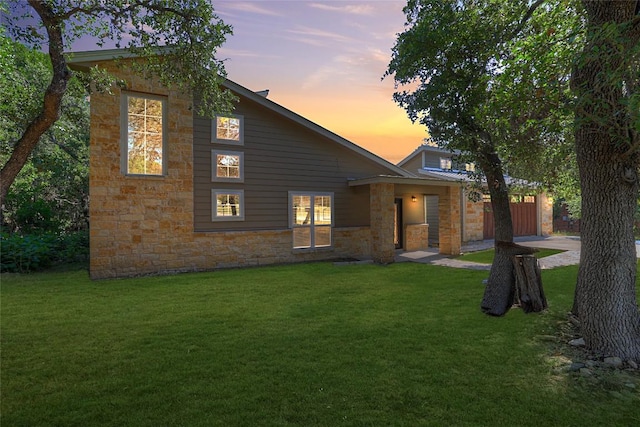 3055 Lakeview Dr, Canyon Lake, TX 78133 - back of property with stone siding, a lawn, and a garage