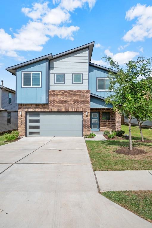 10208 Criswell Rd, Austin, TX 78754 - contemporary home featuring brick siding, a garage, concrete driveway, and board and batten siding