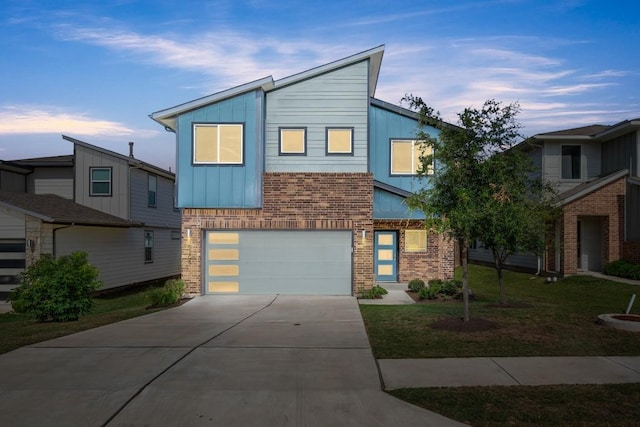 10208 Criswell Rd, Austin, TX 78754 - contemporary house featuring brick siding, a garage, concrete driveway, and board and batten siding