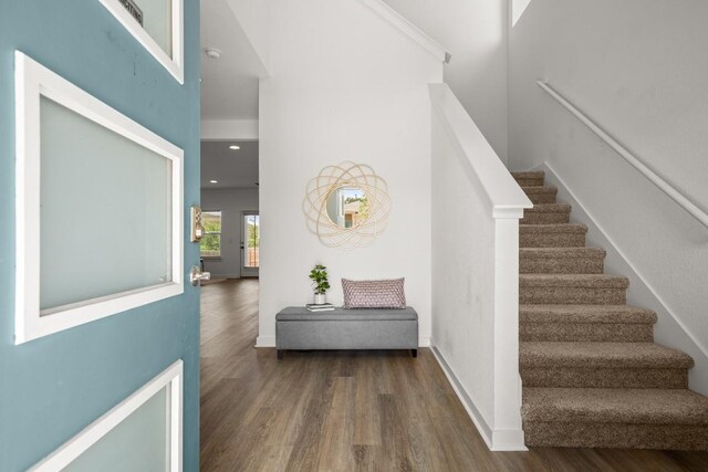 10208 Criswell Rd, Austin, TX 78754 - stairs featuring wood finished floors, a towering ceiling, and baseboards