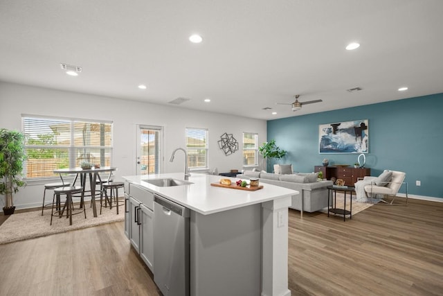 10208 Criswell Rd, Austin, TX 78754 - kitchen featuring stainless steel dishwasher, a sink, wood finished floors, light countertops, and recessed lighting