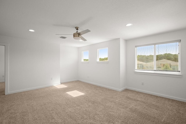 10208 Criswell Rd, Austin, TX 78754 - spare room with light carpet, baseboards, a ceiling fan, and recessed lighting
