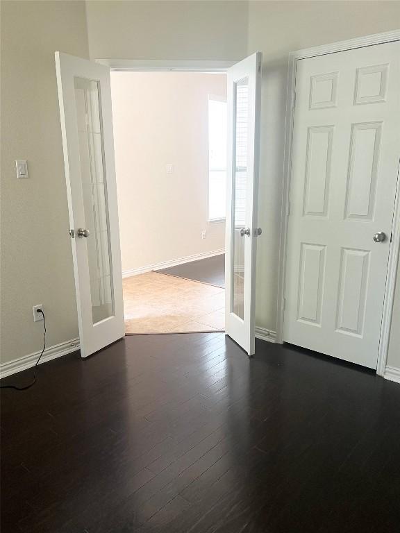 10016 Wading Pool Path, Austin, TX 78748 - unfurnished room with french doors, baseboards, and dark wood finished floors