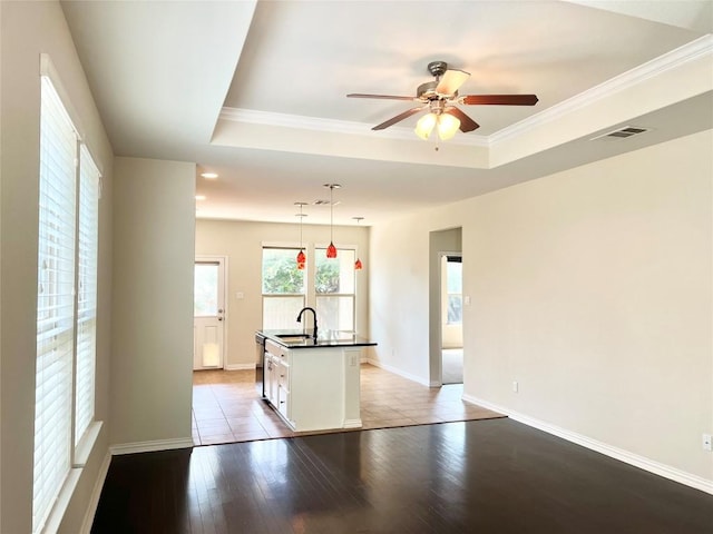 10016 Wading Pool Path, Austin, TX 78748 - empty room featuring a ceiling fan, ornamental molding, a tray ceiling, light wood-style flooring, and baseboards
