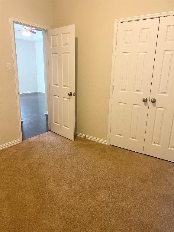 10016 Wading Pool Path, Austin, TX 78748 - unfurnished bedroom featuring carpet floors, baseboards, and a closet