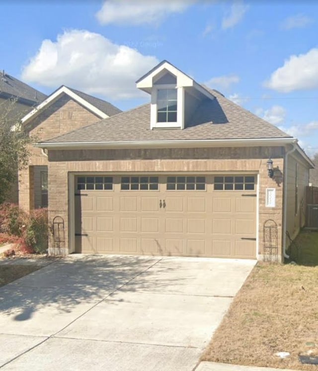 10016 Wading Pool Path, Austin, TX 78748 - view of front of house featuring an attached garage, concrete driveway, a shingled roof, and brick siding