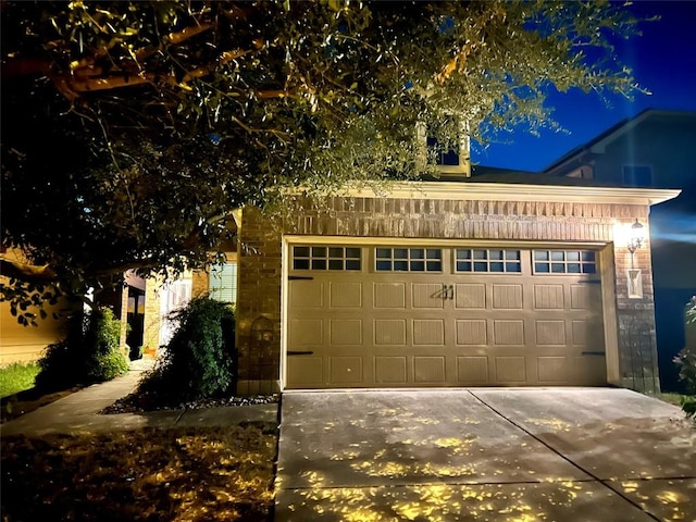 10016 Wading Pool Path, Austin, TX 78748 - garage at night featuring driveway