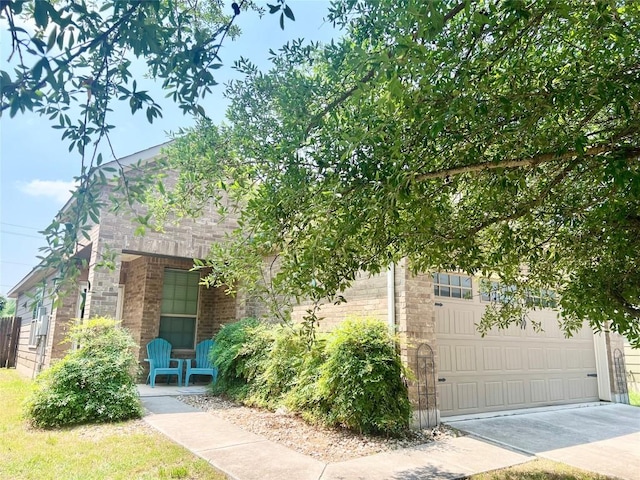 10016 Wading Pool Path, Austin, TX 78748 - obstructed view of property featuring driveway, stone siding, and brick siding