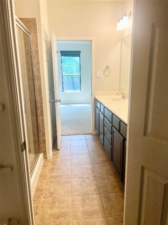 10016 Wading Pool Path, Austin, TX 78748 - bathroom with a stall shower, vanity, and tile patterned flooring