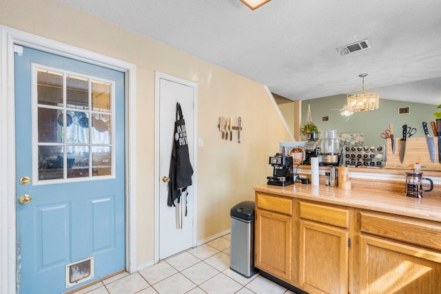 2656 Piping Rock Trl, Austin, TX 78748 - bar area with light tile patterned floors, a chandelier, hanging light fixtures, a textured ceiling, and vaulted ceiling