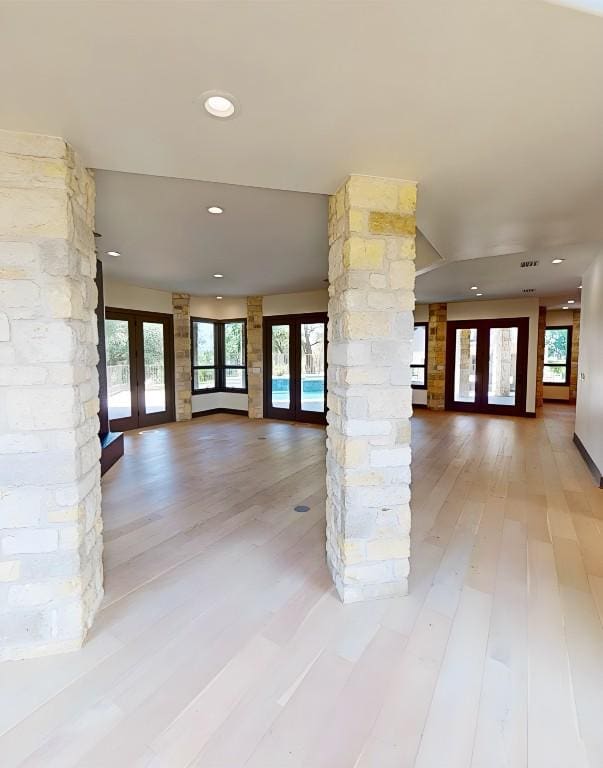 2700 Marina Shores Dr, Spicewood, TX 78669 - unfurnished living room featuring french doors, light wood finished floors, and recessed lighting