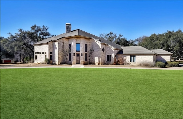 2700 Marina Shores Dr, Spicewood, TX 78669 - view of front of property with a chimney, a front yard, and stone siding