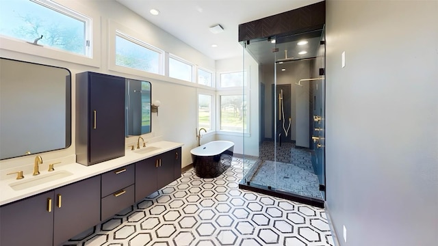 2700 Marina Shores Dr, Spicewood, TX 78669 - full bath with a stall shower, double vanity, a freestanding bath, and recessed lighting