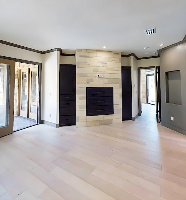 2700 Marina Shores Dr, Spicewood, TX 78669 - unfurnished living room with ornamental molding, baseboards, recessed lighting, and light wood-style floors