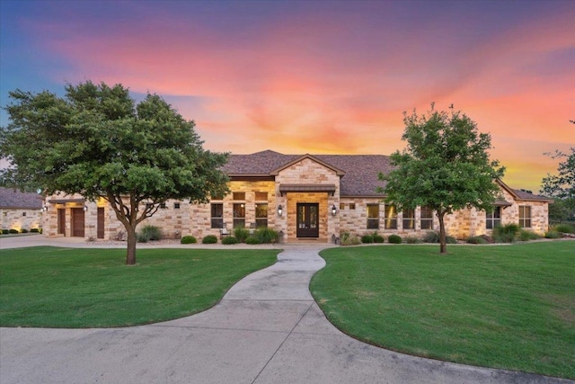 535 Creekside Dr, Salado, TX 76571 - view of front facade featuring stone siding, a lawn, french doors, and driveway