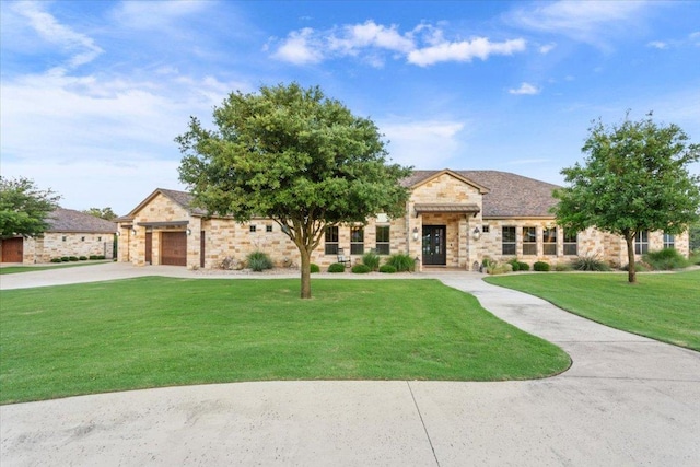 535 Creekside Dr, Salado, TX 76571 - view of front of home with stone siding, driveway, a front lawn, and an attached garage
