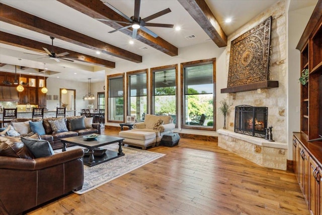 535 Creekside Dr, Salado, TX 76571 - living room featuring ceiling fan, beam ceiling, a stone fireplace, hardwood / wood-style flooring, and recessed lighting