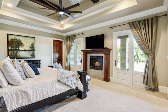 535 Creekside Dr, Salado, TX 76571 - carpeted bedroom with a tray ceiling, a tiled fireplace, crown molding, a ceiling fan, and wooden ceiling
