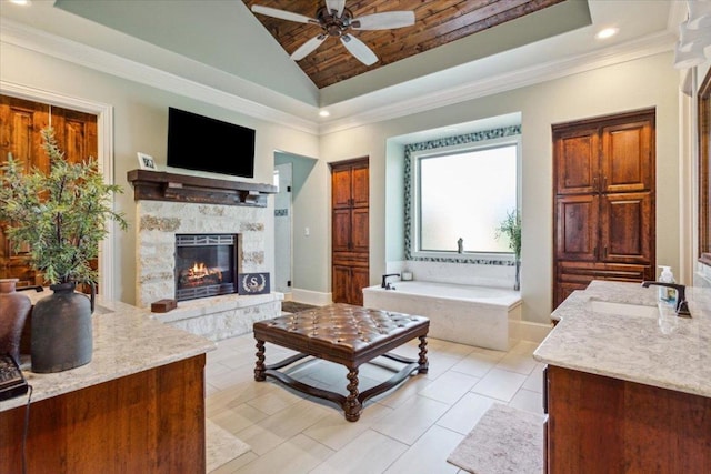 535 Creekside Dr, Salado, TX 76571 - living area featuring a ceiling fan, lofted ceiling, a fireplace, recessed lighting, and ornamental molding