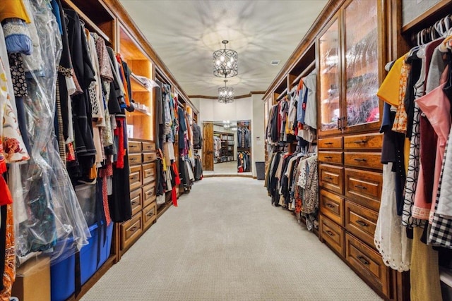535 Creekside Dr, Salado, TX 76571 - walk in closet featuring light carpet and a chandelier