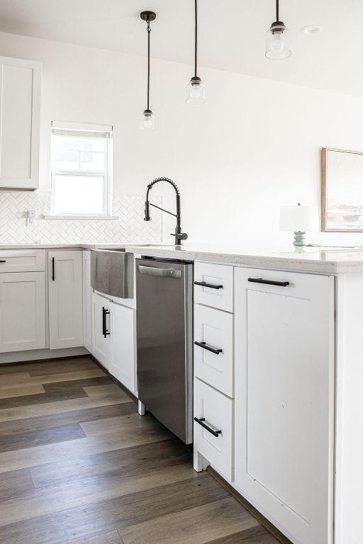 148 Feather Way, Fredericksburg, TX 78624 - kitchen with dishwasher, backsplash, and white cabinets
