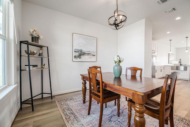 148 Feather Way, Fredericksburg, TX 78624 - dining room featuring light wood-style floors, a chandelier, recessed lighting, and baseboards