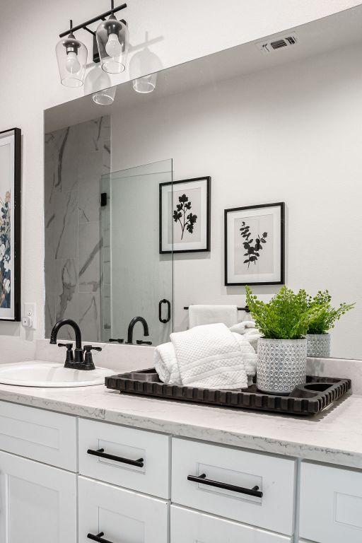 148 Feather Way, Fredericksburg, TX 78624 - bathroom with vanity and a marble finish shower