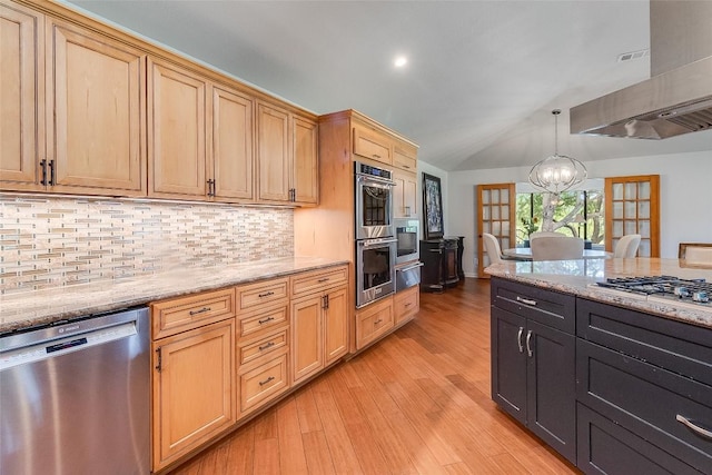 408 Sombrero, Horseshoe Bay, TX 78657 - kitchen with stainless steel appliances, vaulted ceiling, a chandelier, light wood-style flooring, and tasteful backsplash