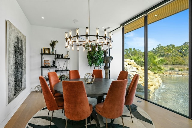 8209 Two Coves Dr, Austin, TX 78730 - dining area with a chandelier, wood finished floors, and expansive windows