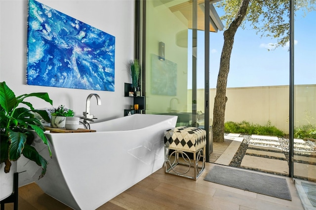 8209 Two Coves Dr, Austin, TX 78730 - full bath with a freestanding bath and wood finished floors