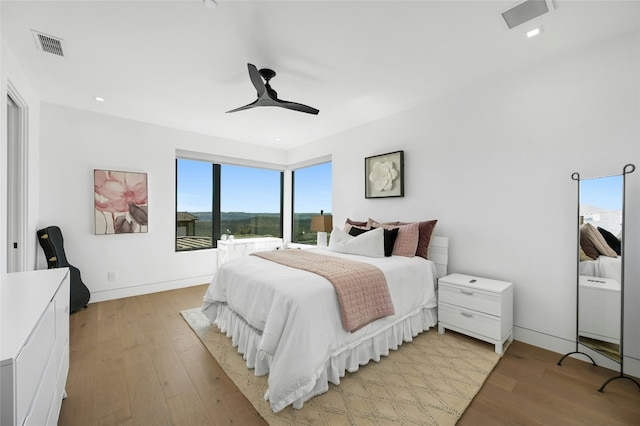 8209 Two Coves Dr, Austin, TX 78730 - bedroom with light wood finished floors, a ceiling fan, and baseboards